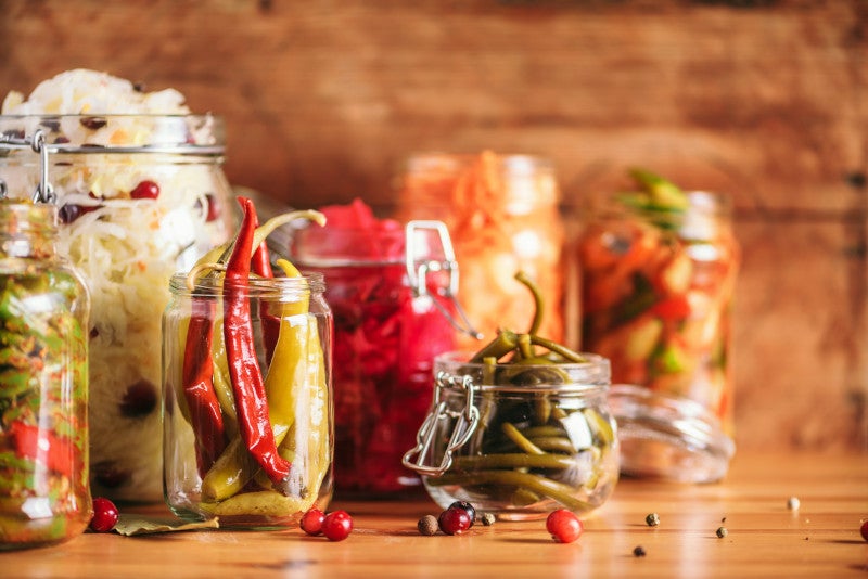 Probiotics food background. Korean carrot, kimchi, beetroot, sauerkraut, pickled cucumbers in glass jars. Winter fermented and canning food concept. Banner with copy space