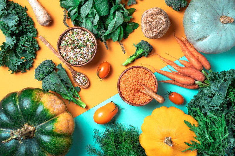 Autumn vegetables, lentils, beans, raw ingredients for cooking on trendy yellow and green background. Embodying the benefits of probiotics on clinical measures or NAFLD/ NASH.