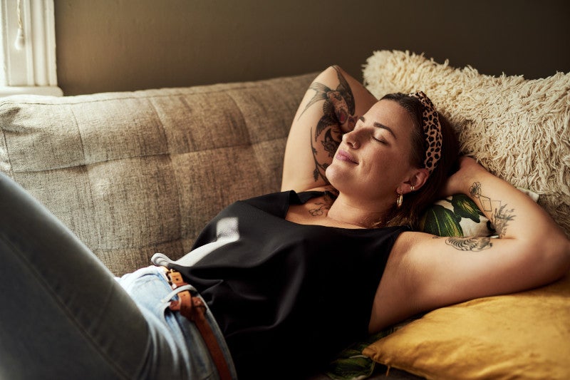 Shot of a young woman relaxing on the sofa at home.