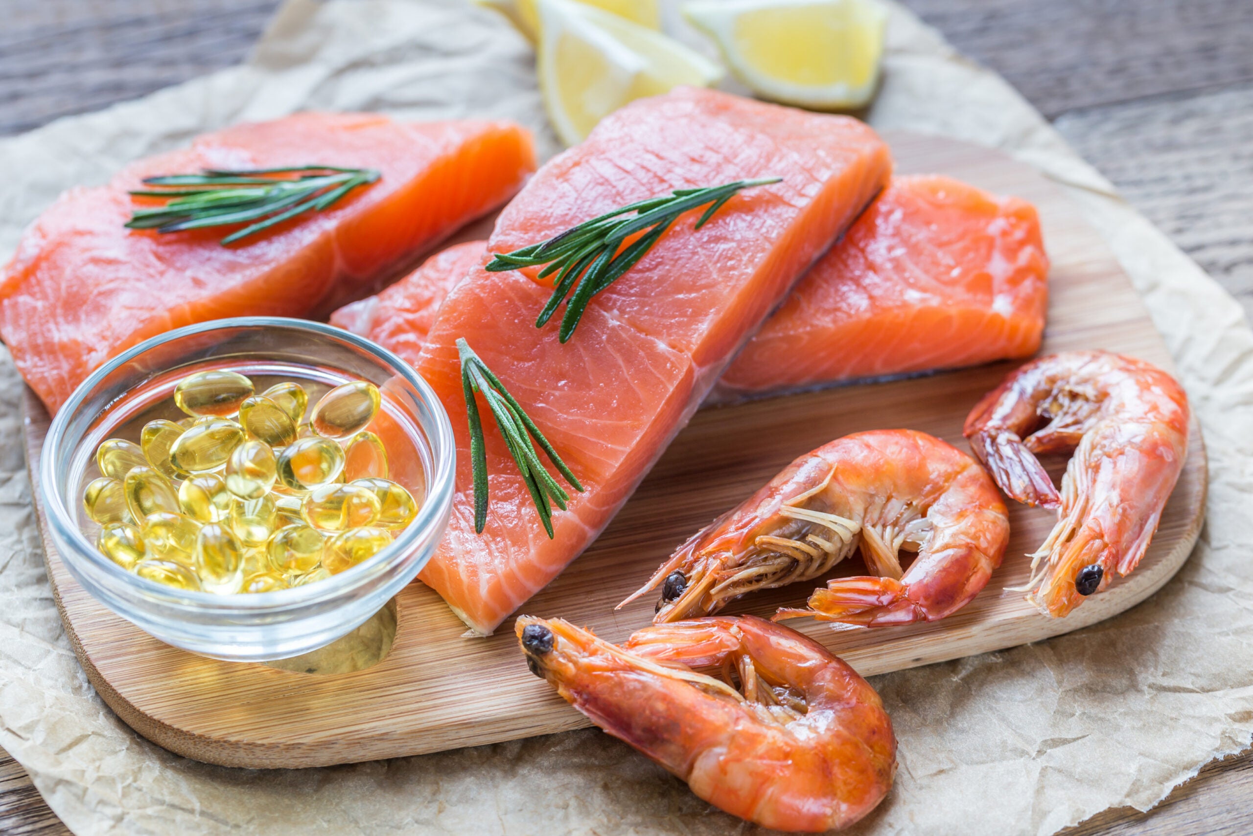 Flat lay of omega-3s, salmon, and shrimp that make up the ketogenic diet, one of the functional medicine treatments for chronic migraines.