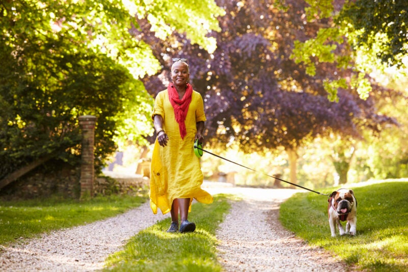 Women walking her dog outdoors