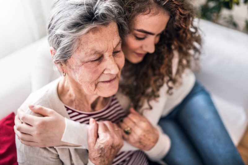 Younger women hugging elderly women