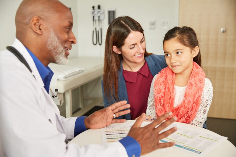 Patient, caregiver and child in an appointment