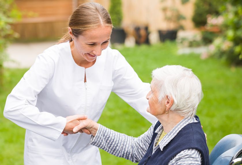 Doctor helping elderly woman